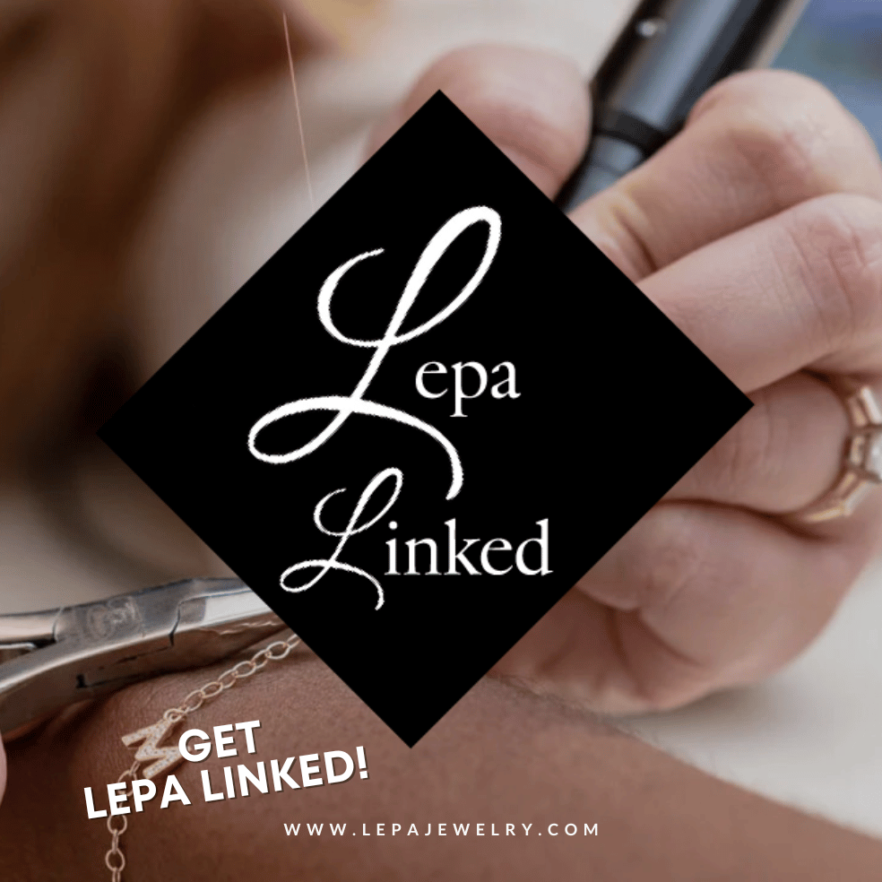 A black triangle with the Logo Lepa Linked created by Empower Communications in West Kentucky for jewelry store Lepa Linked in downtown Benton, KY for their permanent jewelry business.